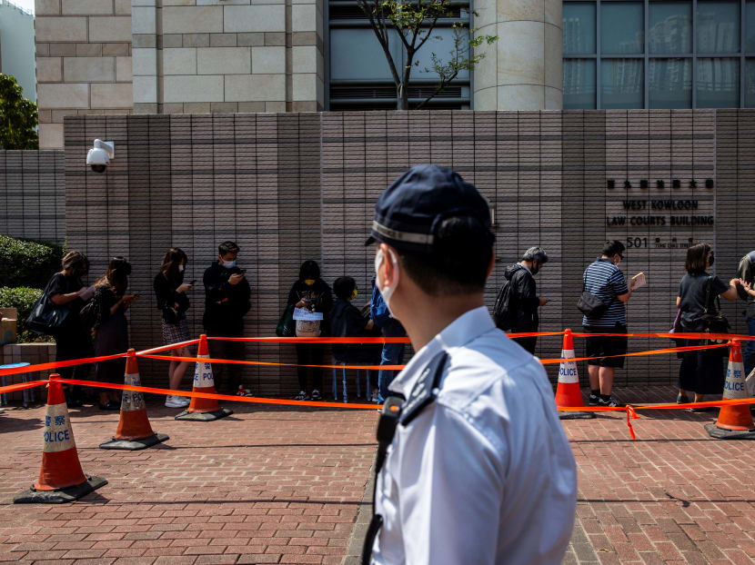 Supporters (back) line up outside West Kowloon court in Hong Kong on March 2, 2021, during court appearances by dozens of dissidents charged with subversion in the largest use yet of Beijing's sweeping new national security law.