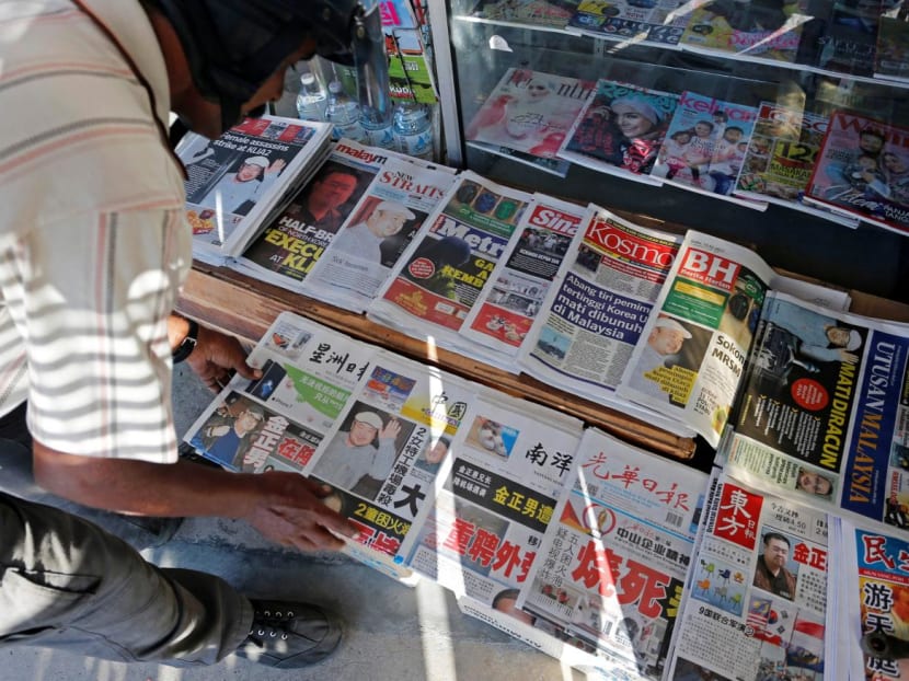 A newspaper vendor arranges newspapers showing front pages with images of Kim Jong-nam, at a news-stand outside Kuala Lumpur, Malaysia.