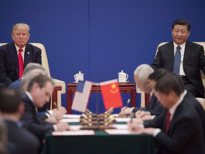 United States President Donald Trump (L) and China’s President Xi Jinping attend a business leaders event inside the Great Hall of the People in Beijing on Thursday (Nov 9). The US inked US$250 billion (S$340.4 billion) in deals as part of Mr Trump’s maiden trip to Beijing. Photo: AFP