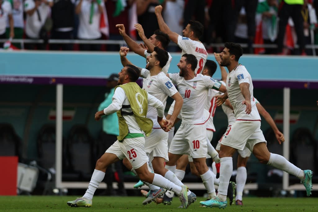Iran's players celebrate their victory during the Qatar 2022 World Cup Group B football match between Wales and Iran at the Ahmad Bin Ali Stadium in Al-Rayyan, west of Doha on Nov 25, 2022.