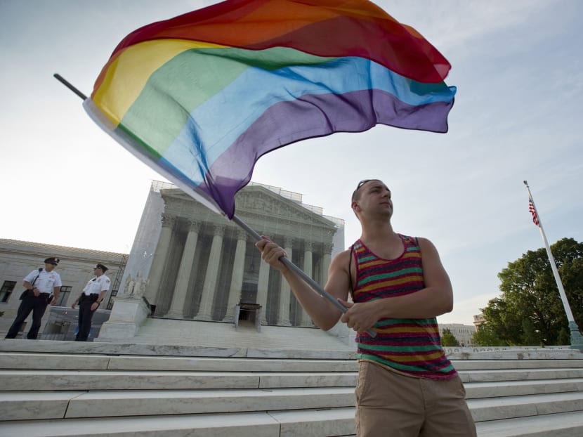 In this June 26, 2013, file photo, gay rights advocate Vin Testa waves a rainbow flag in front of the Supreme Court in Washington. It was announced Friday  that the Supreme Court will decide gay marriage issue this term. Photo: AP