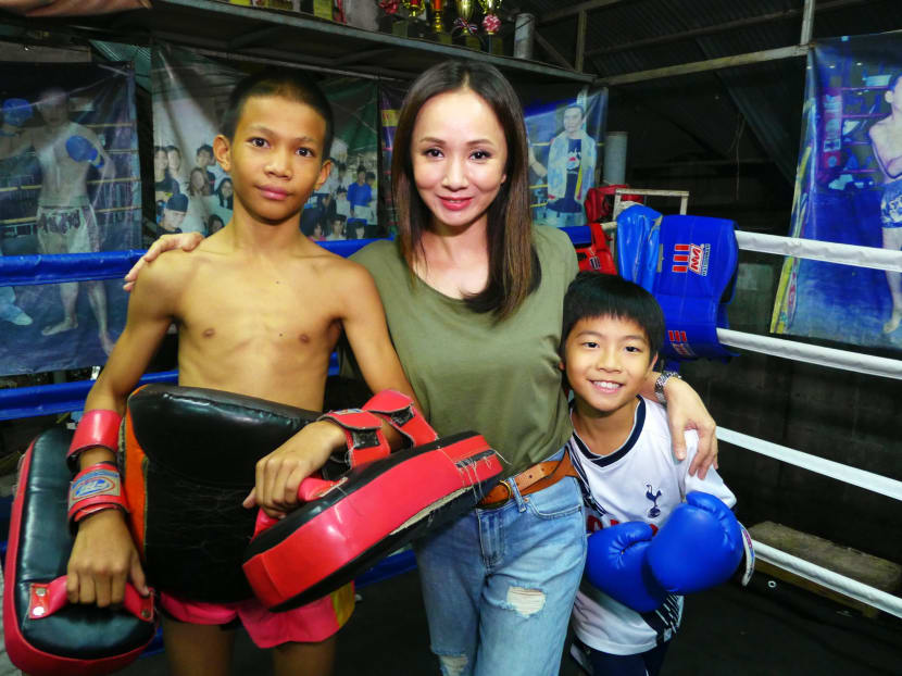 Diana Ser with her son, Jake (right) and a Muay Thai child fighter on location in Chiang Mai, Thailand. Photo: Diana Ser