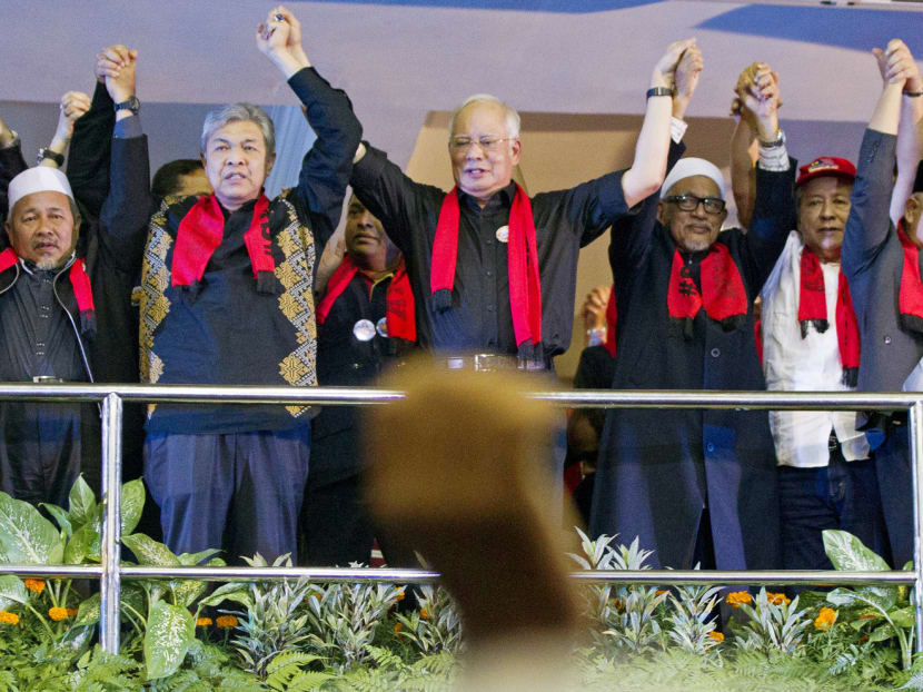 Mr Najib (centre) holding hands with other Malaysian leaders during a protest in Kuala Lumpur against the persecution of Rohingya Muslims in Myanmar. In the past year, Mr Najib has cemented his leadership within Umno and has lent his support to PAS’ Bill of allowing the Syariah courts to mete out heavier punishments in a bid to ensure Umno’s victory at the next general election. Photo: AP