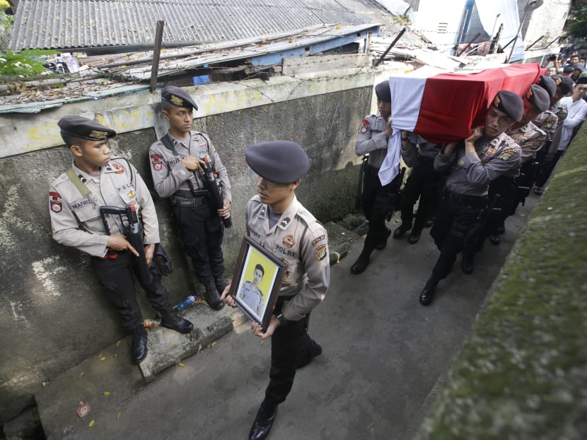 Police officers carry the coffin containing the body of their colleague Sgt, Gilang Imam Adinata who was killed in Tuesday's suicide bombings during a funeral procession in Jakarta, Indonesia, Thursday, May 25, 2017. Photo: AP
