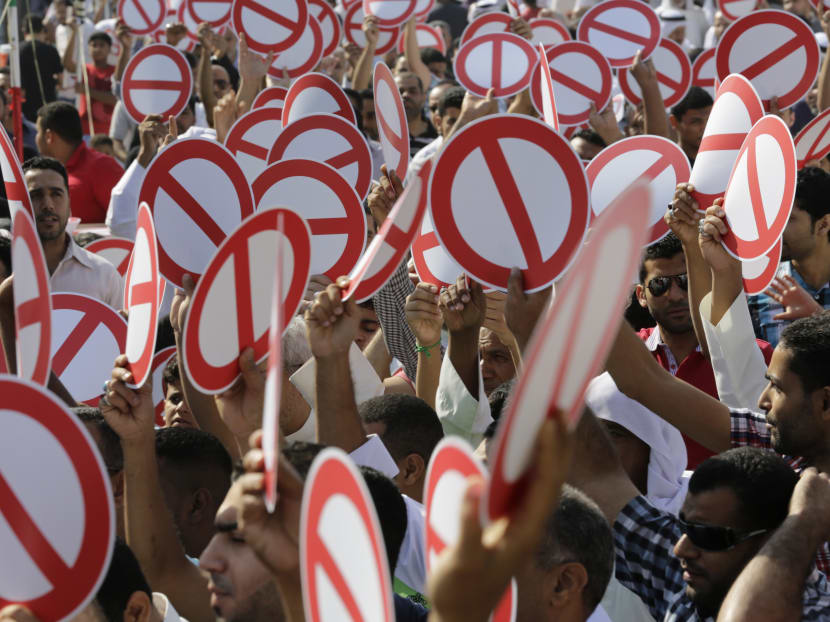 Hundreds of Bahrainis head to the streets for an unauthorised flash march to show their support for an opposition-called boycott of today's parliamentary and municipal elections after midday prayers in Diraz, Bahrain, yesterday. Photo: AP
