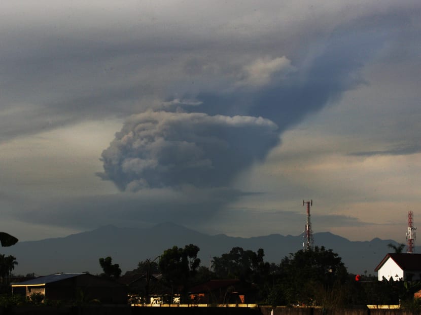 Mount Sinabung spews volcanic materials as it erupts as seen  from Medan, about 70km from Sinabung, North Sumatra, Indonesia, today, Nov 18, 2013. Two volcanoes erupted today in Indonesia, prompting warnings for flights and evacuation preparations, official said. Photo: AP