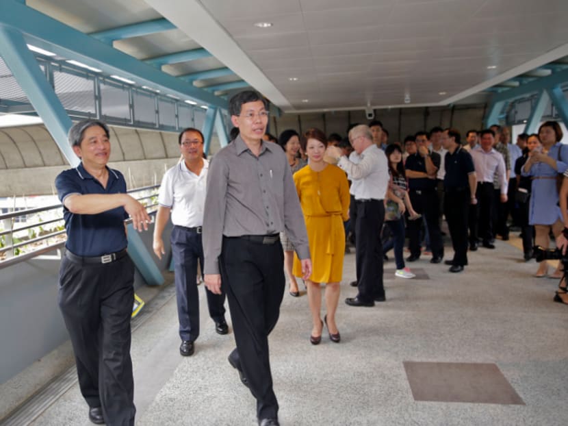 Minister for Transport Lui Tuck Yew (in grey) visiting one of the two new sheltered pedestrian link bridges at Clementi MRT Station today (Aug 25). Photo: Wee Teck Hian Minister for Transport Lui Tuck Yew (in grey) visiting one of the two new sheltered pedestrian link bridges at Clementi MRT Station today (Aug 25). Photo: Wee Teck Hian