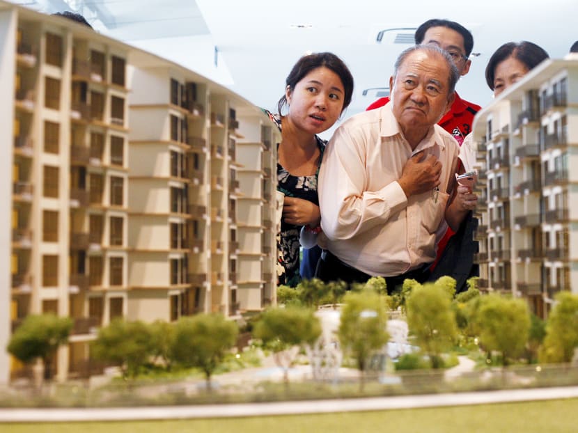 Prospective buyers look at a model of an upcoming suburban private condominium development during its launch in Singapore in this October 25, 2013 file photo. Photo: Reuters
