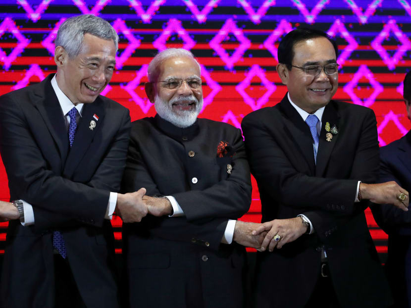 India's Prime Minister Narendra Modi smiles next to Prime Minister Lee Hsien Loong and Thailand's Prime Minister Prayuth Chan-ocha at the Asean-India Summit on the sideline of the 35th Asean Summit in Bangkok, Thailand on Sunday, Nov 3, 2019.