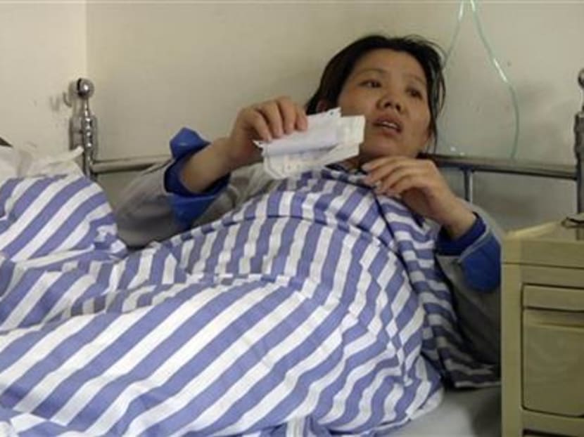 In this image taken from APTN video shot on March 26, 2015, Ms Shi Jieying talks from her sickbed after she was hospitalised with heart trouble at Nanlang hospital in Zhongshan city in southern China’s Guangdong Province. Photo AP