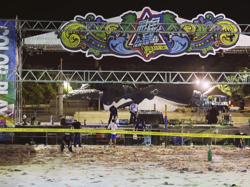 Police investigators inspect the stage area after an accidental explosion during a music concert at the Formosa Water Park in New Taipei City, Taiwan, early Sunday, June 28, 2015. Photo: AP