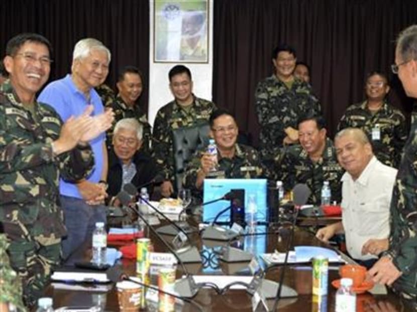 Philippine Military Chief Gen. Gregorio Catapang, center, reacts after learning about the safe repositioning of Filipino peacekeepers in Golan Heights. Photo: AP