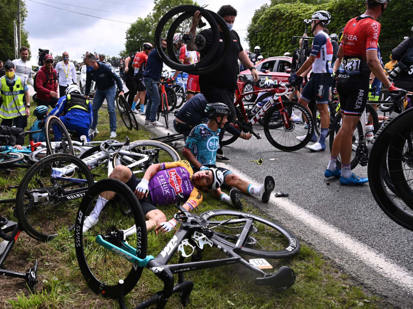 Team B&B KTM's Bryan Coquard of France (right) and a Team Alpecin Fenix' rider lie on the ground after crashing during the 1st stage of the 108th edition of the Tour de France cycling race, on June 26, 2021.
