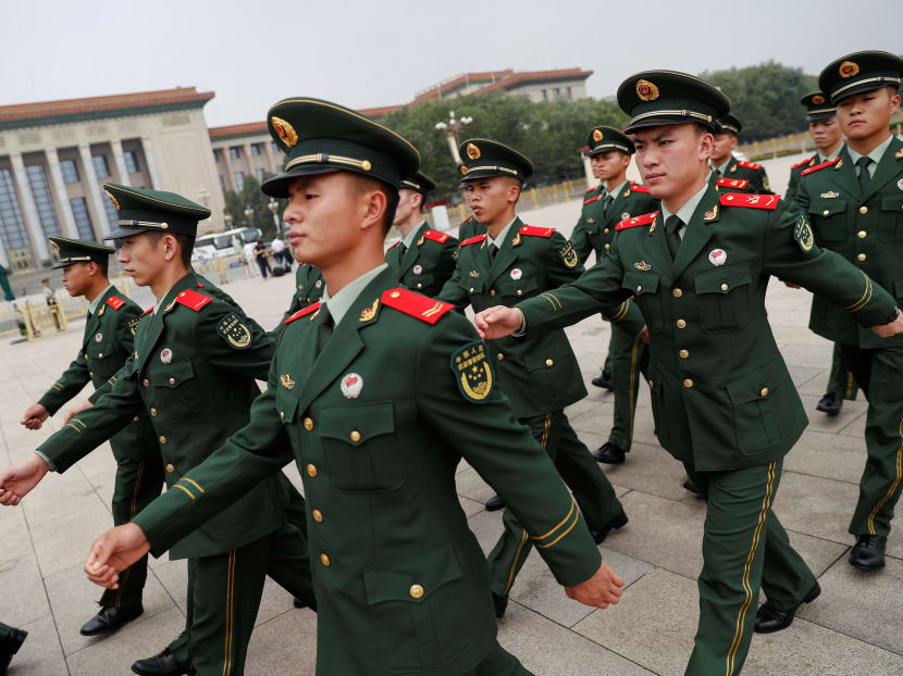 Paramilitary policemen march outside the Great Hall of the People after the ceremony marking the 90th anniversary of the founding of the China's People's Liberation Army in Beijing. Reuters file photo