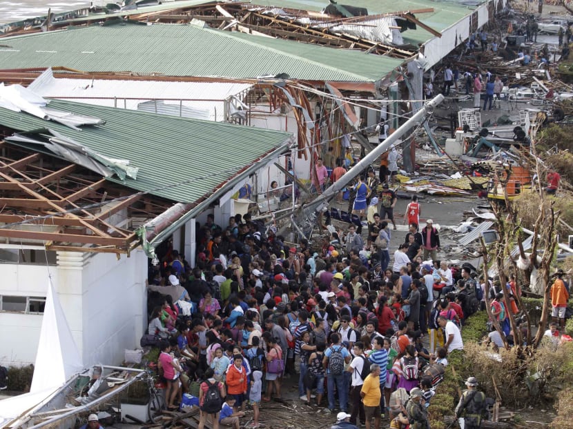Residents queue up to receive treatment and relief supplies at Tacloban airport on Monday Nov11, 2013, following Friday's super typhoon Haiyan that lashed this city and several provinces in central Philippines. Photo: AP