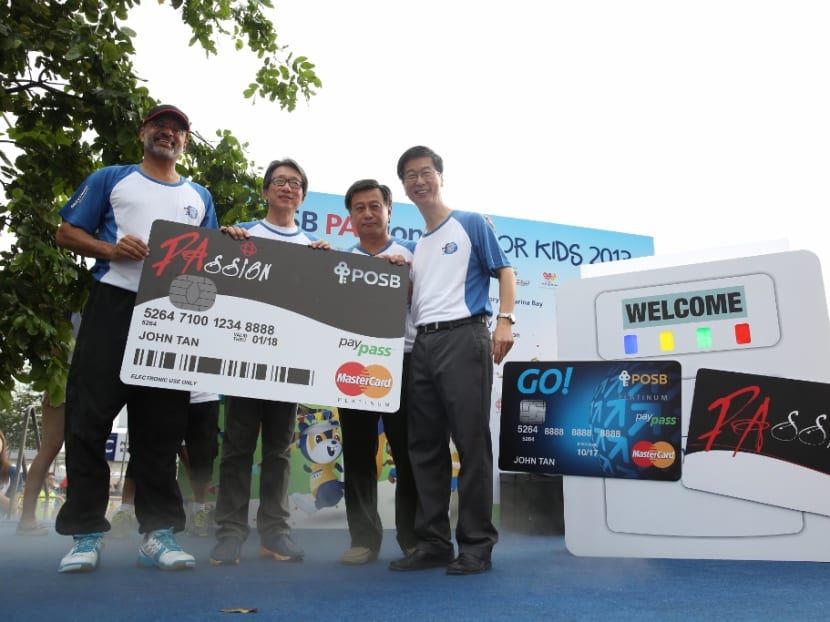 From right, PA Chief Executive Director Ang Hak Seng,  DBS Singapore Country Head Sim S Lim, Minister Lim Swee Say, PA's Deputy Chairman, and DBS Group Chief Executive Piyush Gupta, unveil the PAssion POSB Debit Card. Photo: People’s Association