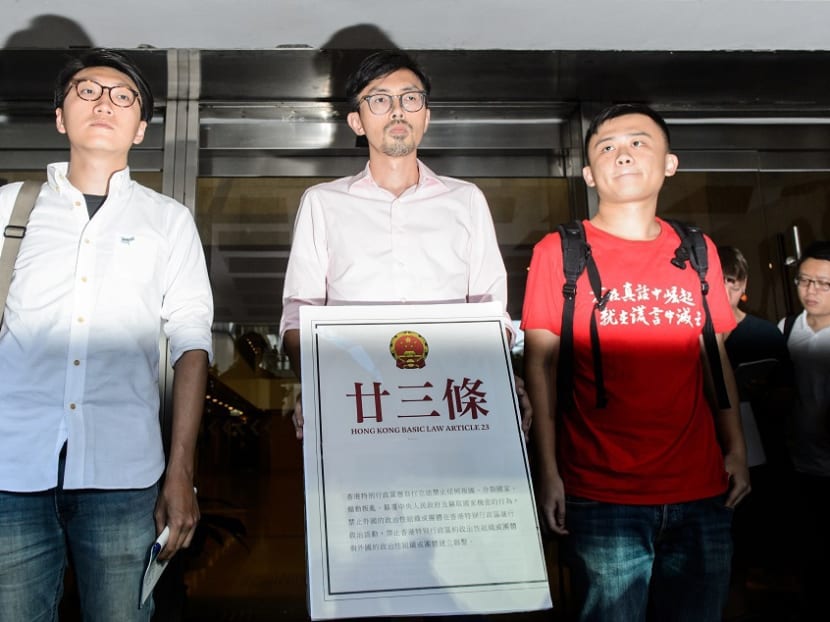 (L to R) Edward Leung of Hong Kong Indigenous, Avery Ng and Chan Tak-cheung from League of Social Democrats prepare to speak to the press after leaving the High Court in Hong Kong on July 27, 2016. Photo: AFP