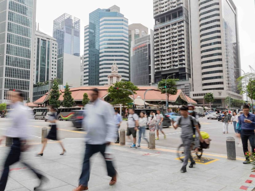 People walking in the Central Business District in Singapore on March 15, 2023.