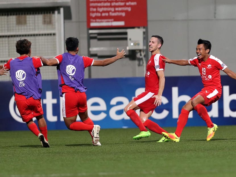 Home United striker Stipe Plazibat (second from right) in wild celebration with his teammates after leading his team to an amazing comeback win. Photo: Wee Teck Hian/TODAY