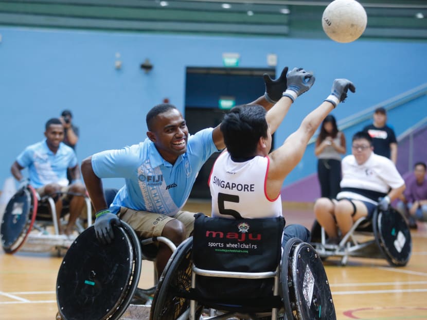 Wise Nacuqu, 24, one of the players from the Olympics Rugby Champions Fiji 7s, trying to intercept the ball during a friendly match against Singapore Wheelchair Rugby at Toa Payoh Sports Hall on Tuesday (April 24). The Fijian team are in Singapore for the ‪2018 HSBC Singapore‬ Rugby 7s, held ‪from April 28 to 29‬ at the National Stadium.