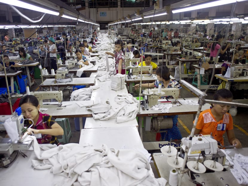 Employees work at the Shweyi Zabe garment factory in Shwe Pyi Thar Industrial Zone in Yangon on September 18, 2015. Photo: AFP