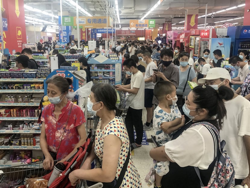 This photo taken on Aug 2, 2021 shows people buying items at a supermarket in Wuhan, in China's central Hubei province, as authorities said they would test its entire population for Covid-19 after the central Chinese city where the coronavirus emerged reported its first local infections in more than a year.