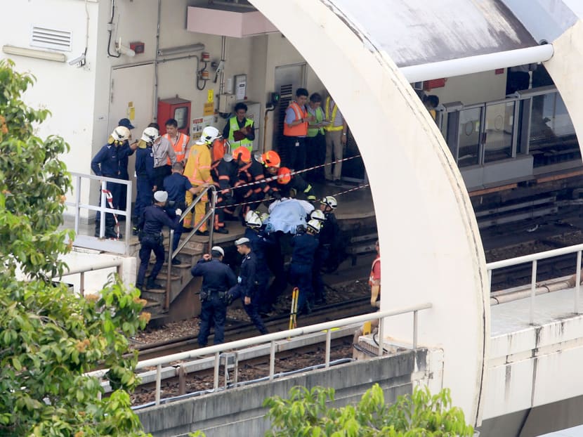 SCDF officers bringing one of the bodies to the platform at Pasir Ris MRT Station on March 22, 2016. TODAY file photo