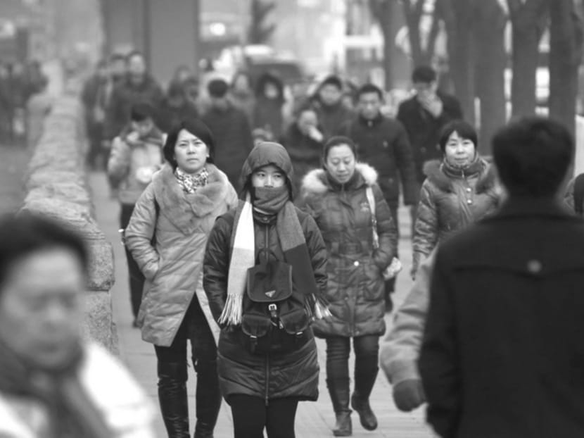 Pedestrians in Beijing’s central business district. China simply cannot afford to continue to kick the reform can down the road. Photo: Bloomberg