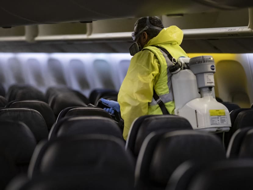 A member of Charles de Gaulle airport personnel nebulises the interior of an Air France aircraft as part of a disinfection process for airplane, in Terminal 2 of Charles de Gaulle international airport in Roissy near Paris, France on May 14, 2020.