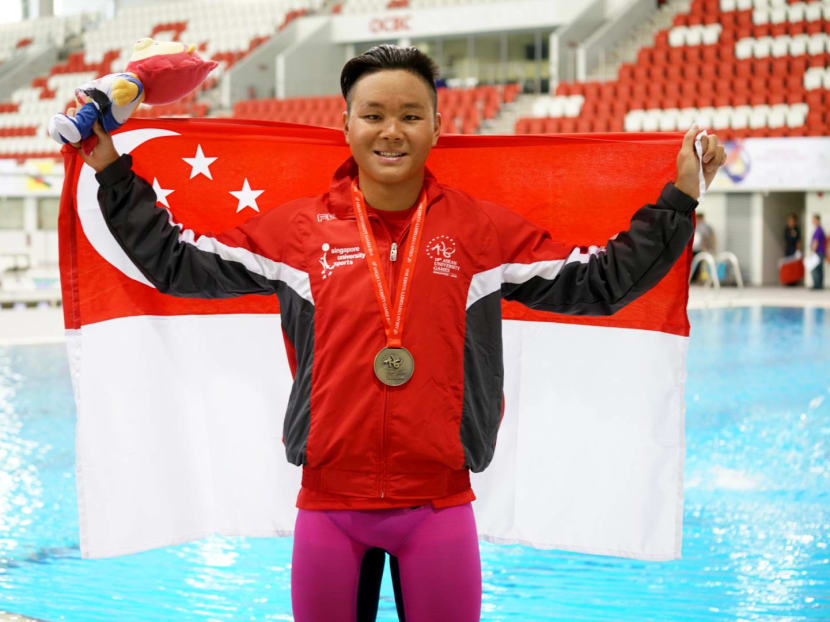 Pang Sheng Jun proudly displaying his winner's medal after his record-breaking swim at the Asean University Games. Photo: NTU Facebook page