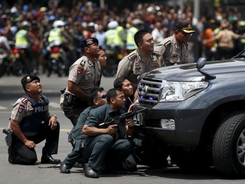 Police officers react near the site of a blast in Jakarta, Indonesia, on Jan 14, 2016. Photo: Reuters