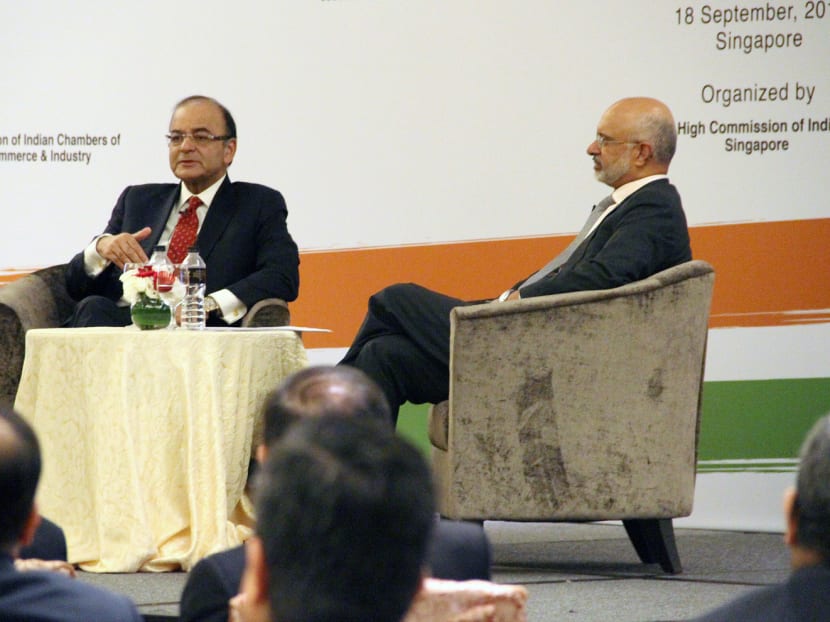 Indian Finance Minister Arun Jaitley (left) speaking at the dialogue session yesterday at Marina Bay Sands during his two-day visit in Singapore. Mr Jaitley assured investors here that India was no longer suffering from policy paralysis and an uncertain taxation regime. Photo: Daryl Kang