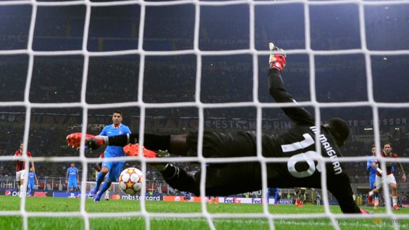 Last-gasp Suarez penalty earns Atletico victory over 10-man Milan Last-gasp Suarez penalty earns Atletico victory over 10-man Milan