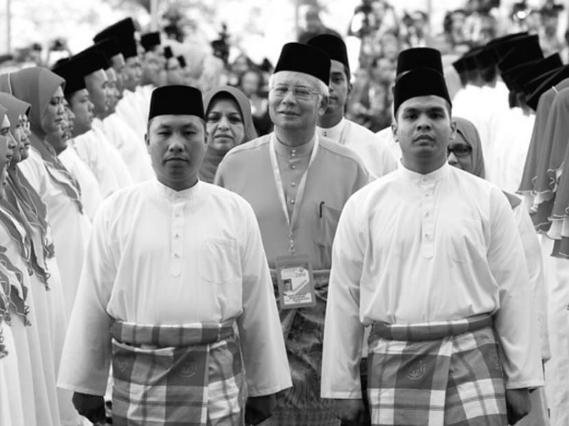 Mr Najib Razak inspecting UMNO youth in Kuala Lumpur yesterday. UMNO Youth believes the Cabinet needs a better combination of young professionals 
and veterans. 
Photo: REUTERS