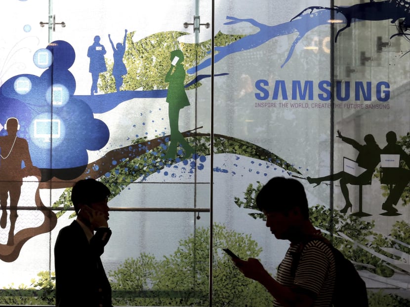People passing by a Samsung Electronics shop in Seoul, South Korea. Samsung on Thursday (July 27) said its second-quarter profit surged 85 percent to record high thanks to memory chips. Photo: AP