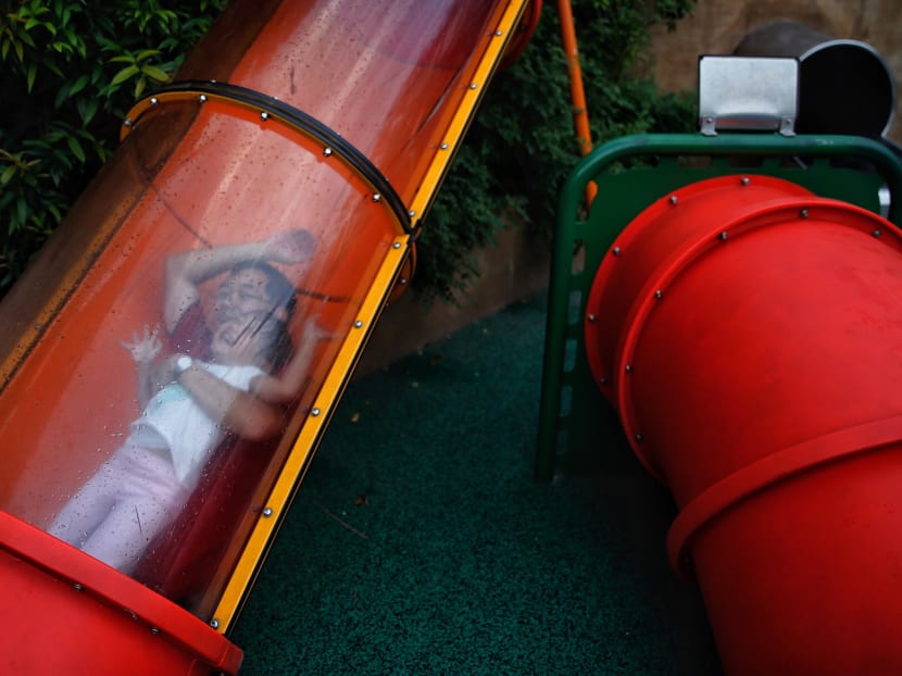 Photo of the day: A father and daughter traversing down a slide at Admiralty Park playground on Sunday evening (June 24). Photo: Najeer Yusof/TODAY