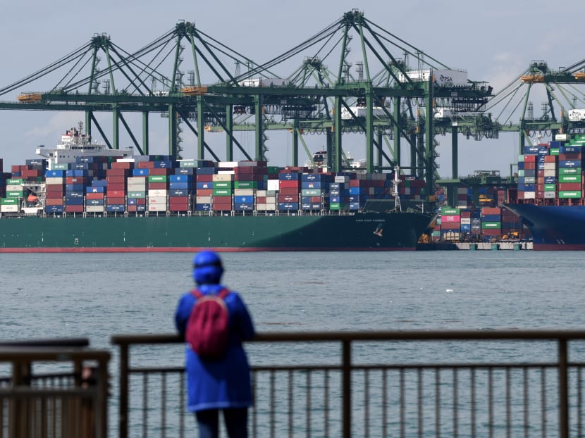 A view of a container vessel docked at the Pasir Panjang container port terminal. A view of a container vessel docked at the Pasir Panjang container port terminal.