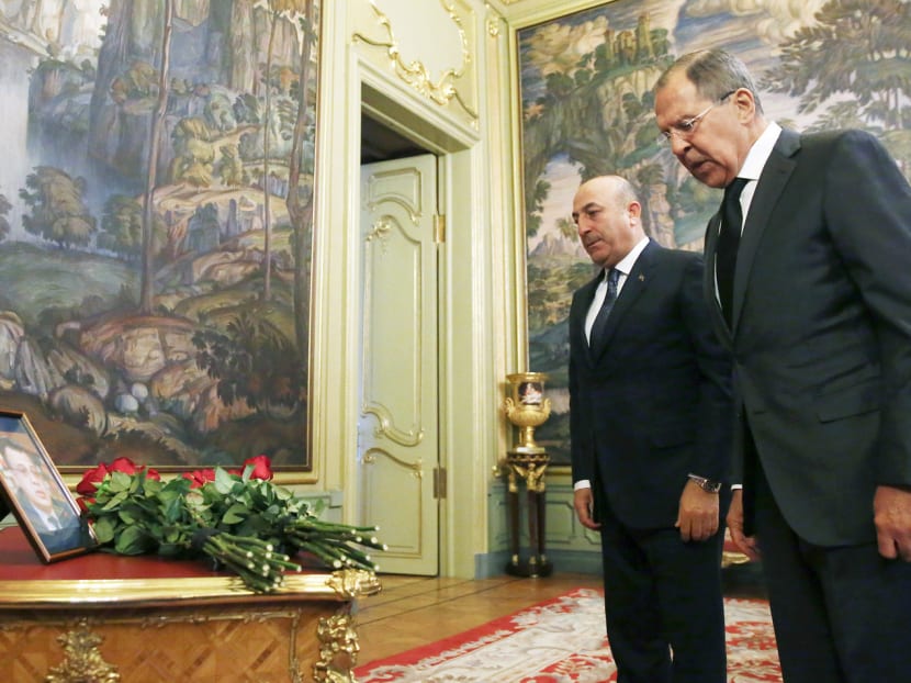 Russian Foreign Minister Sergey Lavrov (right) and his Turkish counterpart Mevlut Cavusoglu attending a ceremony in memory of veteran diplomat Andrei Karlov before their talks in Moscow yesterday. Photo: AP