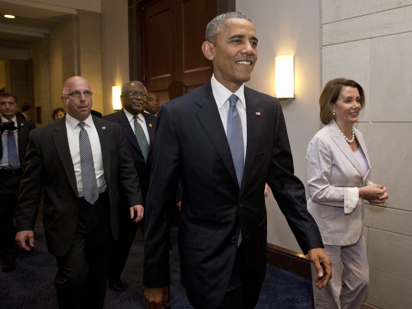 President Barack Obama walks with House Minority Leader Nancy Pelosi of California (right) and House Minority Assistant Leader James Clyburn of South Carolina, as he visits Capitol Hill in Washington, Friday, June 12, 2015, for a meeting with House Democrats.  Photo: AP