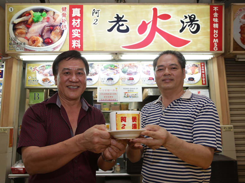 Franchise owners Ma Pit San (left) and Nong Gan standing in front of hawker stall Ah Er Soup at ABC Brickworks Market on June 22, 2017. It is among the nine new entrants to the Michelin Guide Singapore’s Bib Gourmand list for this year. Photo: Wee Teck Hian/TODAY