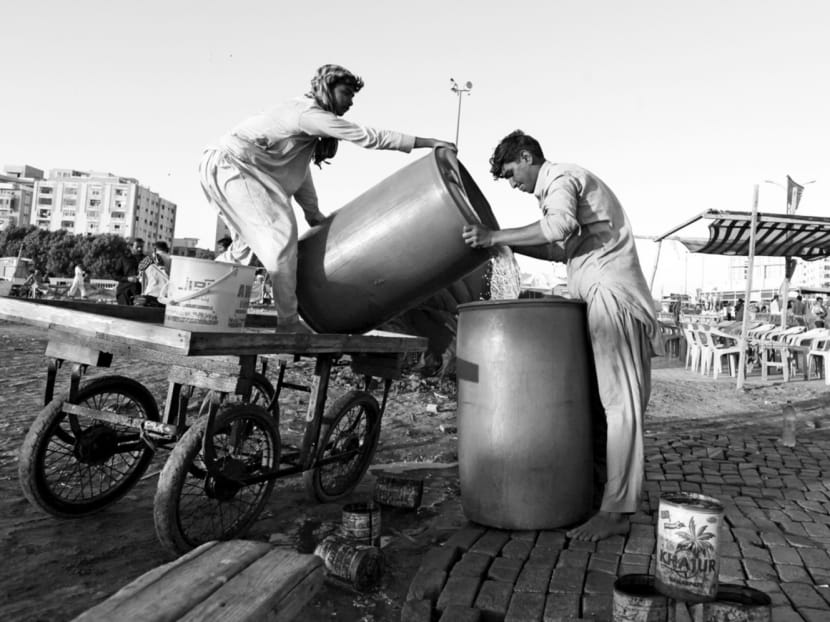 Men pouring water brought by cart into a container in Karachi, Pakistan. Some 3.5 billion people in the world 

do not have access to water that is safe to drink, and in South Asia — with a population of nearly 1.7 billion people — not a single city, town or village can claim that its population has access to safe drinking water. Photo: Reuters