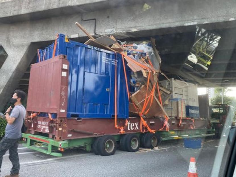 In videos shared on social media, the goods on the trailer appear to hit the top of the 4.5m flyover above the AYE.