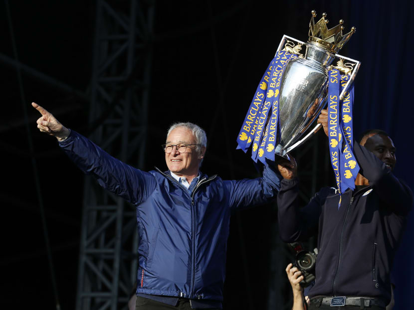 Leicester City manager Claudio Ranieri and Wes Morgan on the stage with the trophy during the parade. Photo: Action Images via Reuters