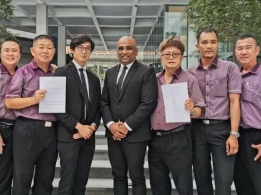 Lawyer M Ravi (centre) with some of the bus drivers in the lawsuit.