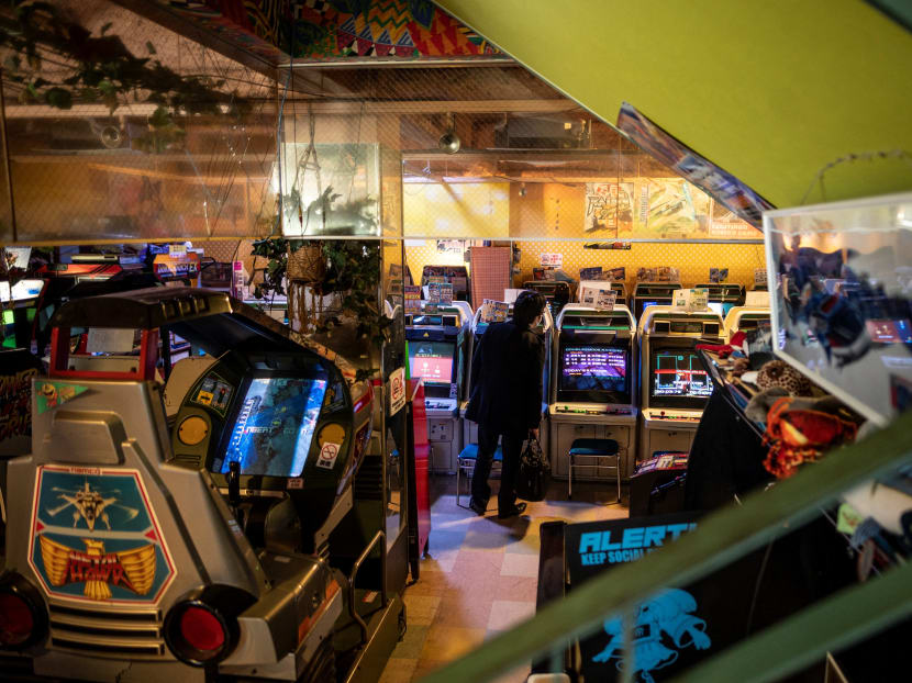 This picture taken on January 26, 2021 shows a man standing in front of arcade game machines at the Mikado game centre in the Shinjuku district of Tokyo. Bright, noisy game centres are still a neighbourhood fixture in Japan, but have been disappearing as business is hit by virus-curtailed opening hours.