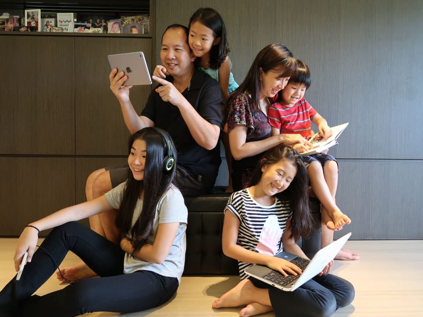 Dr Jiow Hee Jhee and his wife Gladys with their children (clockwise from top left) Gayle, 9, Josiah, 6, Genevieve, 11, and Gabriella, 13. Every child uses media differently and parents should be engaged in their children's media usage, he advised. Photo courtesy Dr Jiow Hee Jhee