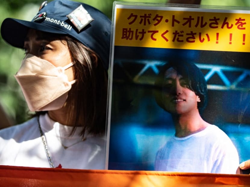 An activists hold a placard of Japanese citizen Toru Kubota, who is detained in Myanmar, during a rally in front of the Ministry of Foreign Affairs in Tokyo on July 31, 2022.
An activists hold a placard of Japanese citizen Toru Kubota, who is detained in Myanmar, during a rally in front of the Ministry of Foreign Affairs in Tokyo on July 31, 2022.