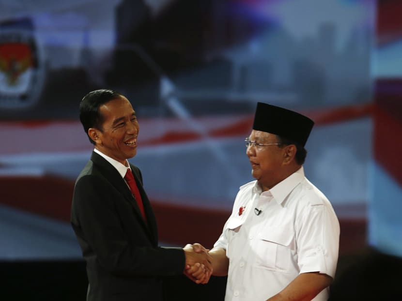 Indonesia's presidential candidate Joko Widodo (left) shaking hands with his opponent, Mr Prabowo Subianto, after a debate in Jakarta on June 15. Photo: Reuters
