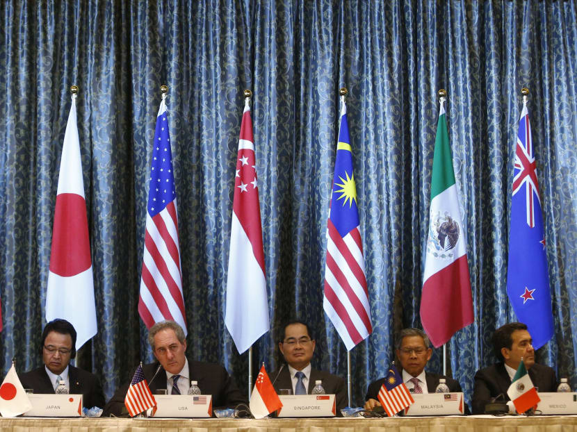 US Trade Representative Michael Froman (centre) speaks next to Japan's Economics Minister Akira Amari (centre left) and Singapore's Trade Minister Lim Hng Kiang (centre right), among trade ministers representing Canada, Peru, Malaysia and Mexico during a news conference at the end of a four-day Trans-Pacific Partnership (TPP) Ministerial meeting in Singapore on Feb 25, 2014. Photo: Reuters