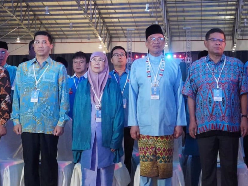 PKR president Anwar Ibrahim (second from right) and his deputy Azmin Ali (second from left) at the party congress.